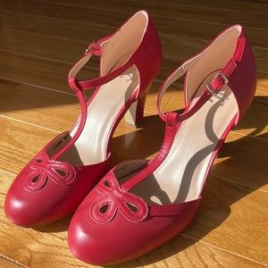 Never worn, red T-strap heels.